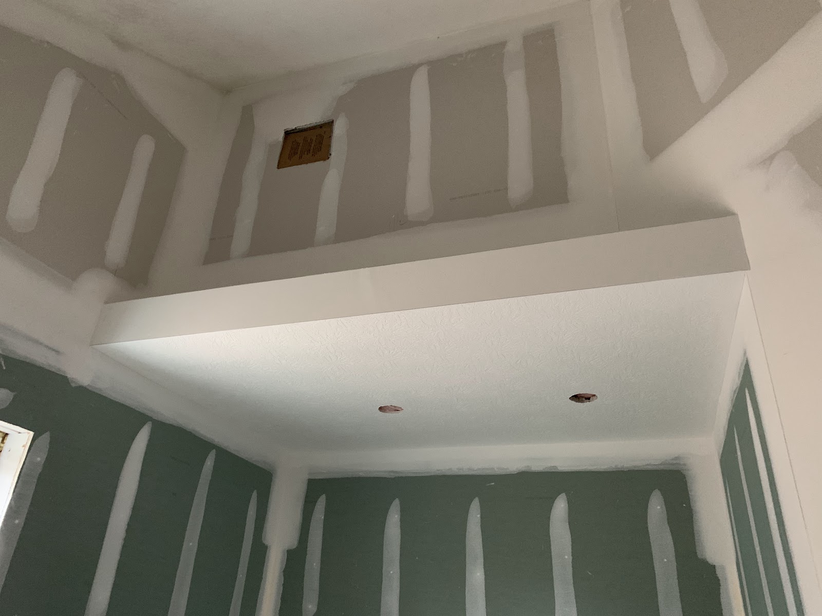 Cathedral ceiling drywall above a finished room
