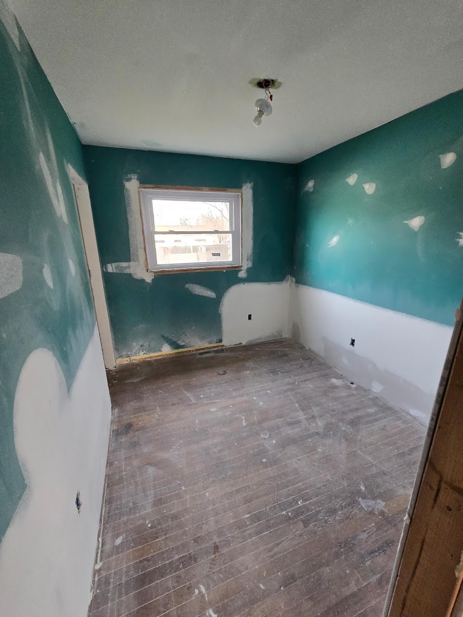 Ceiling patch and repair in a teal-walled room