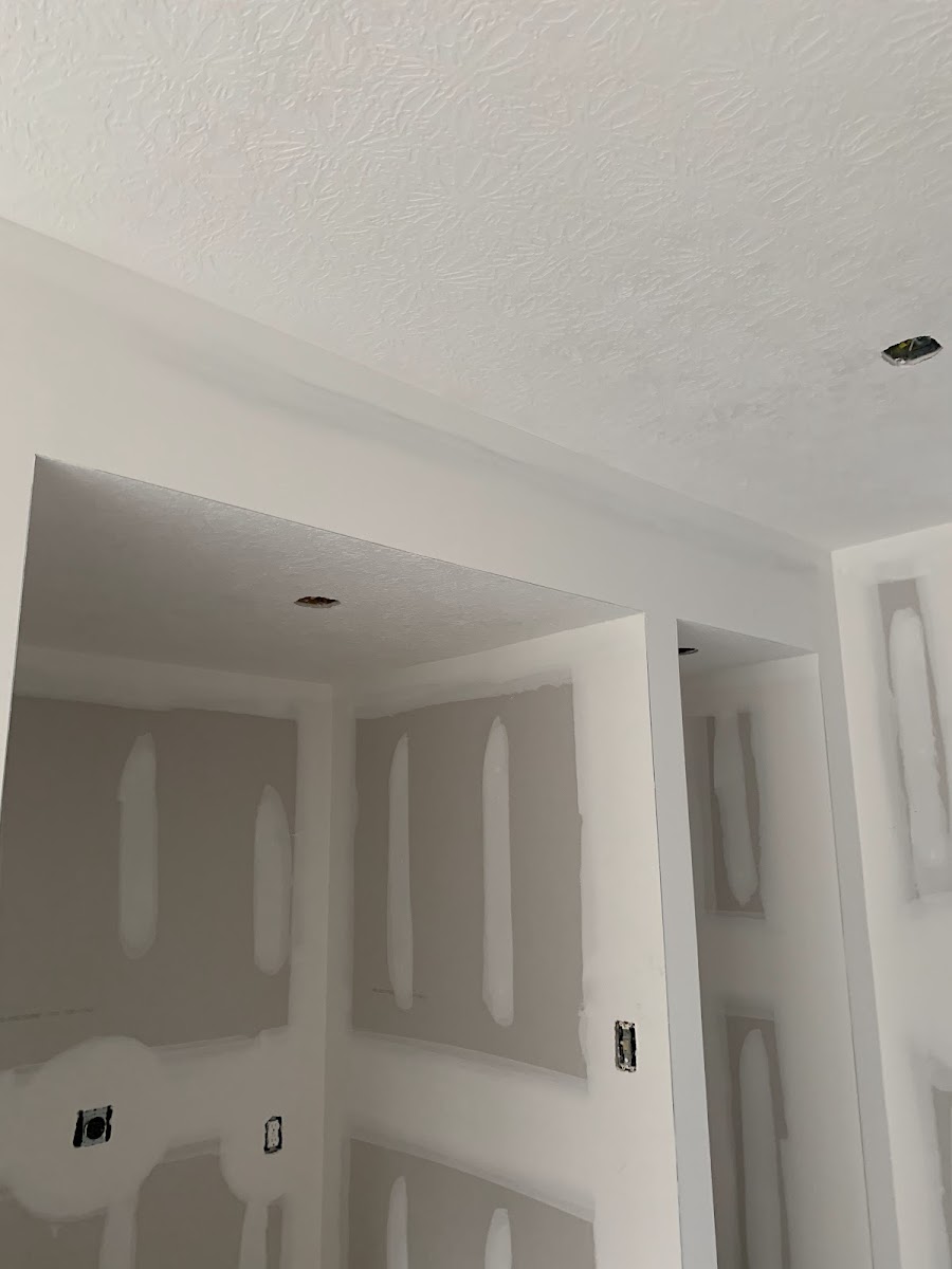 Taped and finished drywall corners in a new room